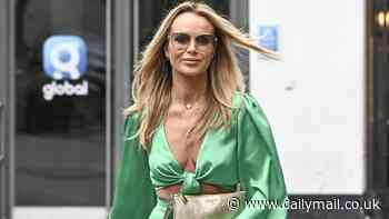 Amanda Holden flashes her cleavage in a plunging satin green jumpsuit as she departs Heart Radio studios