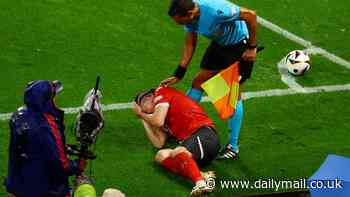 Austria midfielder Marcel Sabitzer struck by an object thrown from the crowd in Euro 2024 last-16 tie... as Turkey star Arda Guler is targeted by rival fans