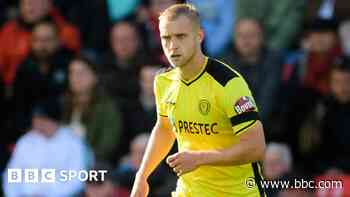 Stockport sign Burton defender Hughes