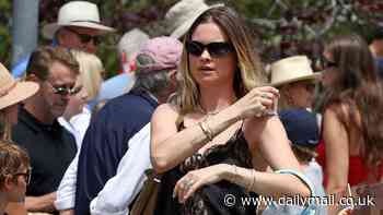 Behati Prinsloo beats the heat in black lace cami with daughters Dusty and Gio at Independence Day parade in California