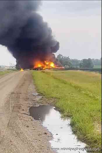 Fiery railcars with hazardous material mostly contained after derailment in North Dakota