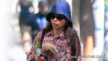 Zoe Kravitz shows off her bohemian style as she rocks a flannel shirt and bucket hat while stepping out in NYC