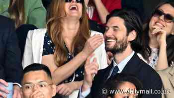 Isla Fisher looks giddy as she chats to a hunky British actor Ben Barnes in the stands on day eight of Wimbledon following her split from Sacha Baron Cohen