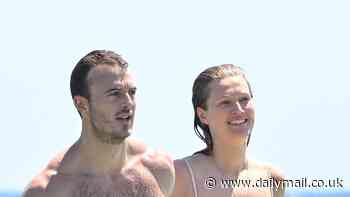 Toni Garrn flaunts her washboard abs in a skimpy bikini as she puts on a loved-up display with her new boyfriend in Saint Tropez