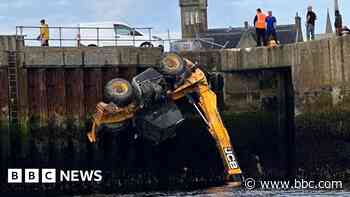 JCB crashes over harbour wall after driver loses control