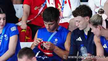 Diving star Tom Daley gets his KNITTING out at the Olympics while watching women's event
