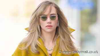 Suki Waterhouse puts on a VERY leggy display in a mustard mini dress as she steps out to promote her new single