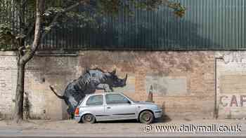 Banksy unveils EIGHTH animal-themed artwork in as many days: Mural of a rhino mounting a Nissan Micra with a traffic cone on its bonnet appears in south east London