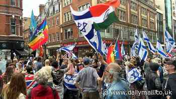 'Tens of thousands' of pro-Palestinian protesters march on Israeli embassy in London where hundreds-strong counter-demo flying flags of Israel lie in wait