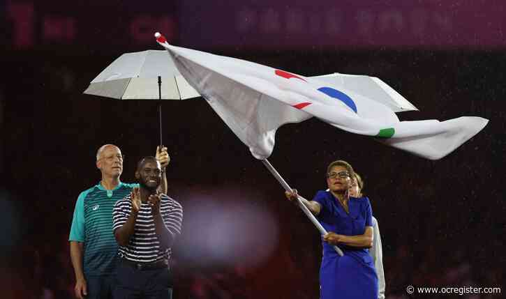 LA28’s rainy Paris rerun: Bass again accepts flag for LA’s next games, this time for paralympics