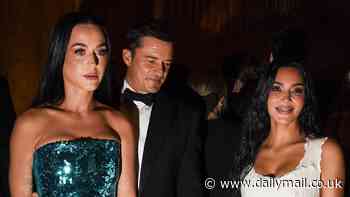 Orlando Bloom seems to sneak a peek at Kim Kardashian's pert posterior as he joins fiancée Katy Perry at Kering Foundation's Caring for Women gala