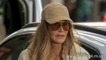 Elle Macpherson goes make-up free as she keeps it casual while jetting out of Australia after controversial 'holistic' breast cancer treatment claims