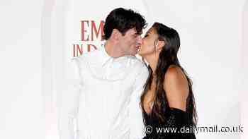 Ashley Park shares a lingering kiss with off-screen boyfriend Paul Forman as they attend the Rome premiere of Emily In Paris - after crediting him for 'saving her life' during sepsis battle