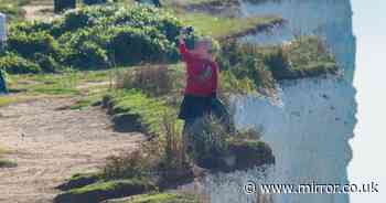 Tourist pictured risking life for selfie by 'very fragile' 530ft cliff edge at UK beauty spot