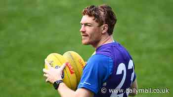 Footy star shows off gruesome scar on his head as he stuns teammates by returning to training just days after suffering a fractured skull