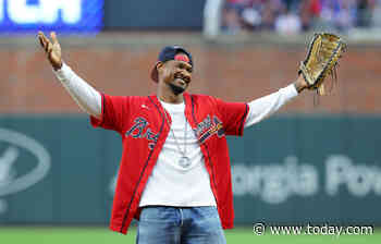 Usher does a little shimmy as he tosses the first pitch at a Braves game: See the video