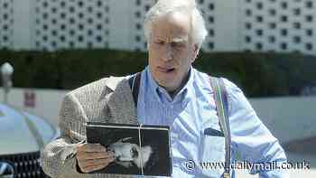 Happy Days are here again: Henry Winkler, 78, seen with a copy of his memoir while paying homage to Farrah Fawcett