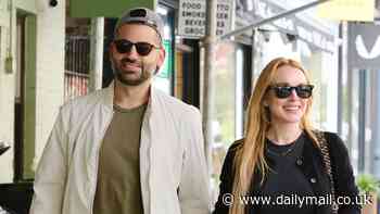 Lindsay Lohan and husband Bader Shammas stroll hand-in-hand after she stunned at Michael Kors fashion show