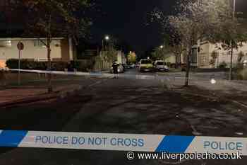 Police cars on cordoned off street as man in serious condition