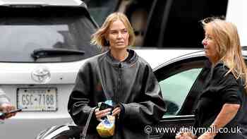 Lara Worthington covers up her tiny frame in baggy jeans and a leather jacket as she goes shopping with her mother - after transforming her figure  with Pilates and a radical food change