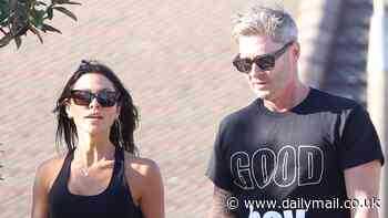 Who's a good boy? Michael Clarke pokes fun at his turbulent love life with a tongue-in-cheek T-shirt while exercising with new girlfriend Arabella Sherborne