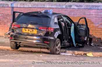 Police close road as three men hurt after car ploughs into wall