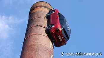 Is it really THAT hard to find a parking space in London? Baffled passers-by wonder why Nissan Qashqai is hanging from chimney in capital