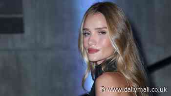 Rosie Huntington-Whiteley shows off her sophisticated style in a backless black jumpsuit at the launch party of £280 skincare product in London