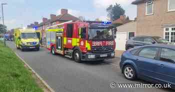 Carshalton house fire horror as firefighters forced to rush into burning home to save woman