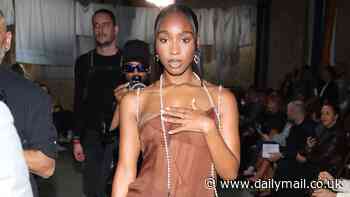 Normani suffers an awkward wardrobe mishap in a racy sheer brown dress at Moschino's show during Milan Fashion Week