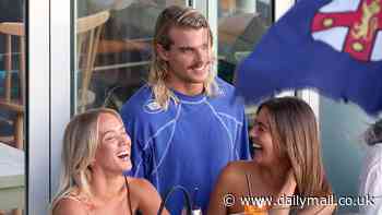 Letting his hair down! AFL heartthrob Bailey Smith downs shots at a Bondi bar and chats up two attractive women after announcing his trade request from Western Bulldogs