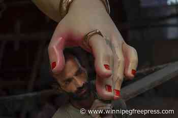 An AP photographer captures an artist working on an idol of Hindu god Ganesha ahead of festival