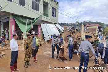 Myanmar soldiers help clean up after a typhoon that killed more than 380 people