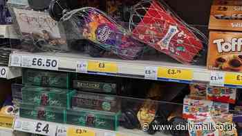 Now that's what you call getting into the Christmas spirit! Tesco places security tags and nets around £3 QUALITY STREET boxes