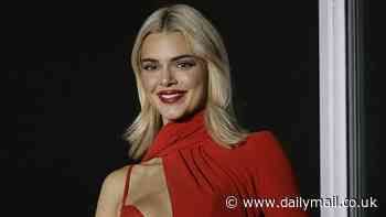 Kendall Jenner looks ravishing as she flashes her bra beneath a racy red cut-out dress while appearing on a balcony during L'Oréal's Paris Fashion Week show