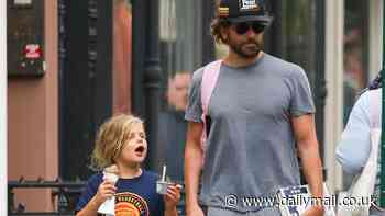 Bradley Cooper is a doting dad as he stops to tie 7-year-old daughter Lea's shoelace during New York City outing