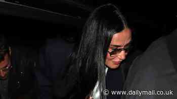 Demi Moore catches the eye in camel combat trousers and SLIPPERS as she arrives at London's BMI for a Q&A