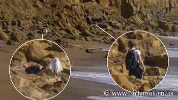 Shocking moment woman sunbathes on fallen debris right underneath Broadchurch cliffs which have seen several recent major rockfalls