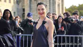 Gal Gadot cuts a stylish figure in a black leather dress as she attends Loewe show for Paris Fashion Week