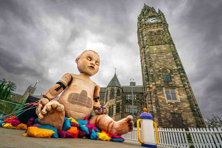 Propaganda for our School Children in the U.K.   Giant Baby Doll in Town Square to Teach Children About Climate Change