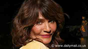 Helena Christensen puts on a leggy display in a pastel baby blue mini dress and yellow bomber jacket as she arrives at Victoria Beckham's Paris Fashion Week show