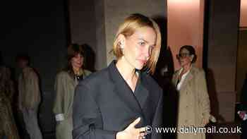 Lara Worthington cuts a chic figure in an oversized black coat at Vetements fashion event in Paris