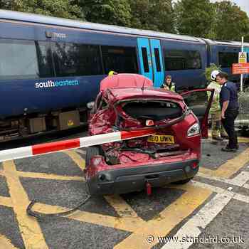 Train smashes into car at level crossing as driver makes lucky escape