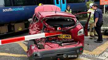 Train smashes into Nishan Qashqai broken down on level crossing - as driver escapes with just seconds to spare