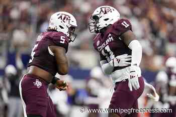 Marcel Reed throws for 2 touchdowns and runs for another in No. 24 Aggies’ 21-17 win over Arkansas