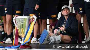 Lions star Lachie Neale parties in moon boot as Brisbane footy fans celebrate premiership