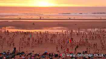 Nude awakening! 1,200 brave skinny dippers dash into the freezing North Sea for charity