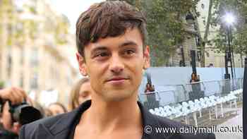 Tom Daley wears a semi-sheer vest and embellished belt to the Stella McCartney show during Paris Fashion Week after announcing his retirement from diving