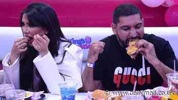 Amir Khan and his wife Faryal Makhdoom tuck into a sandwich as they attend the launch of King's Castle