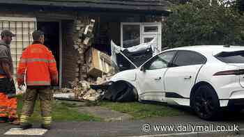 Terrifying moment £80,000 Jaguar I-PACE surges out of control before mounting pavement and ploughing into bungalow